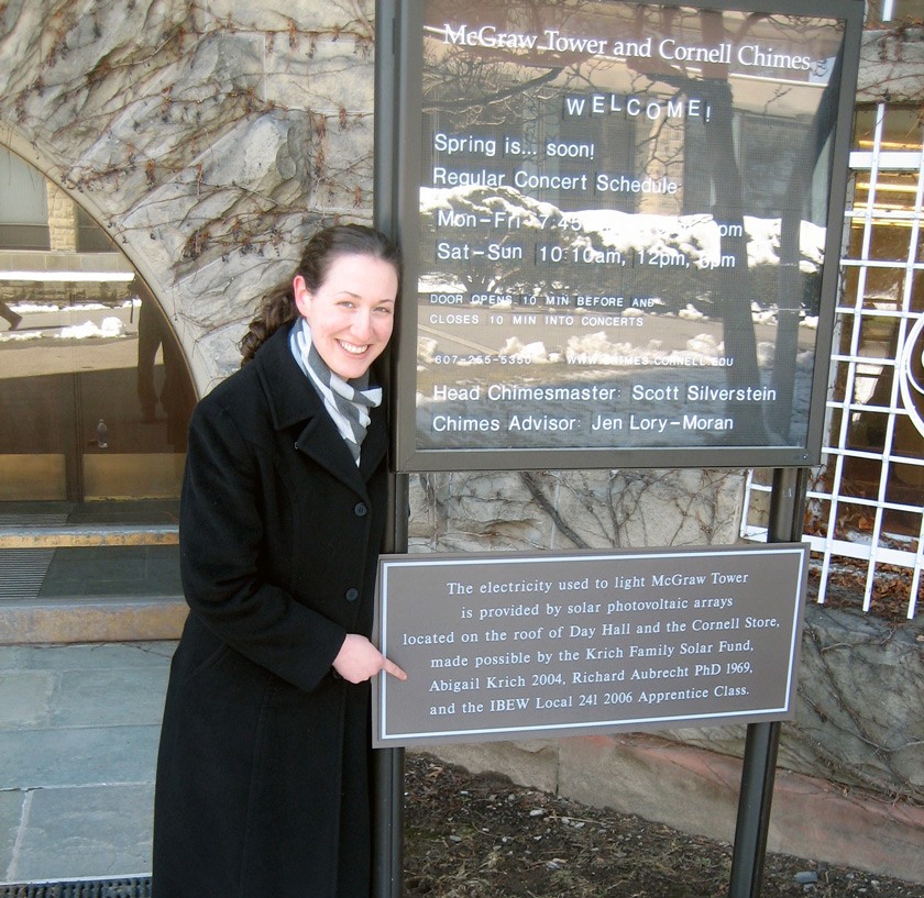 The energy from Cornell’s first solar installation on Day Hall was equivalent to the energy needed to light the Clocktower. Here, Abby poses next to the sign honoring her and others who helped with this effort.