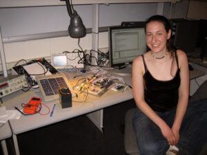 Abby poses with her final project, a solar-powered sunlight meter and data logger, which she built for her MEng microcontrollers class in spring 2006.