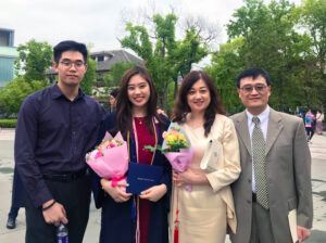 Angela celebrates her high school graduation with her family.