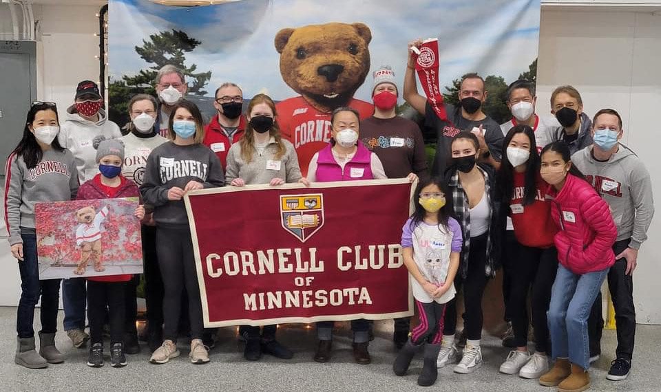 Volunteers with a Cornell Club of Minnesota sign
