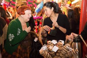 Isela at a Cinco de Mayo event, sharing her products with attendees. The woman on the left is Lynn Yaeger, a contributing editor at Vogue.