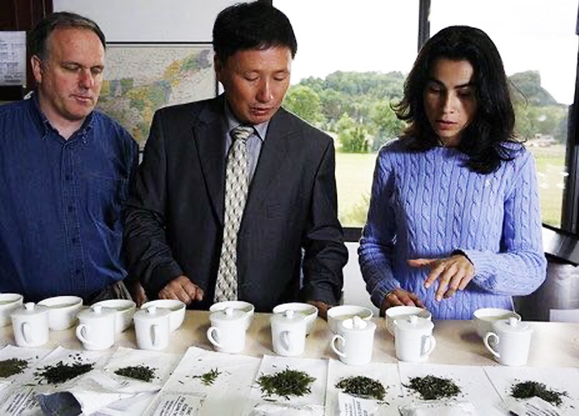 Mike Harney ’77 (left) tasting tea with a Chinese supplier, Mr. Lu (center), and Mike's assistant, Ms. Cardenas (right)