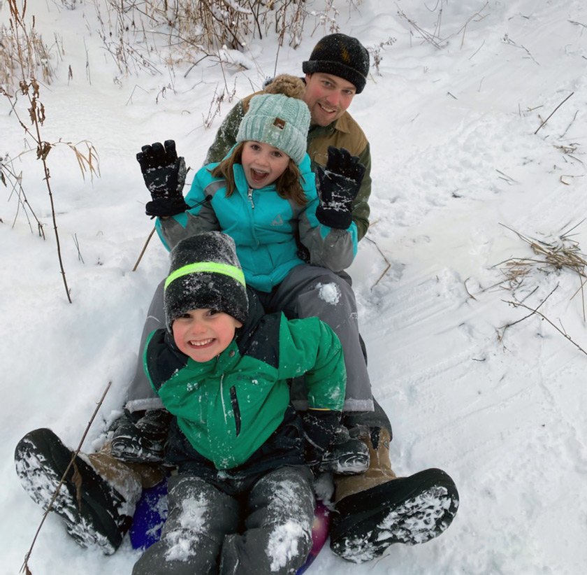 Jordan Boersma playing in the snow with his niece Natalie and nephew Gideon