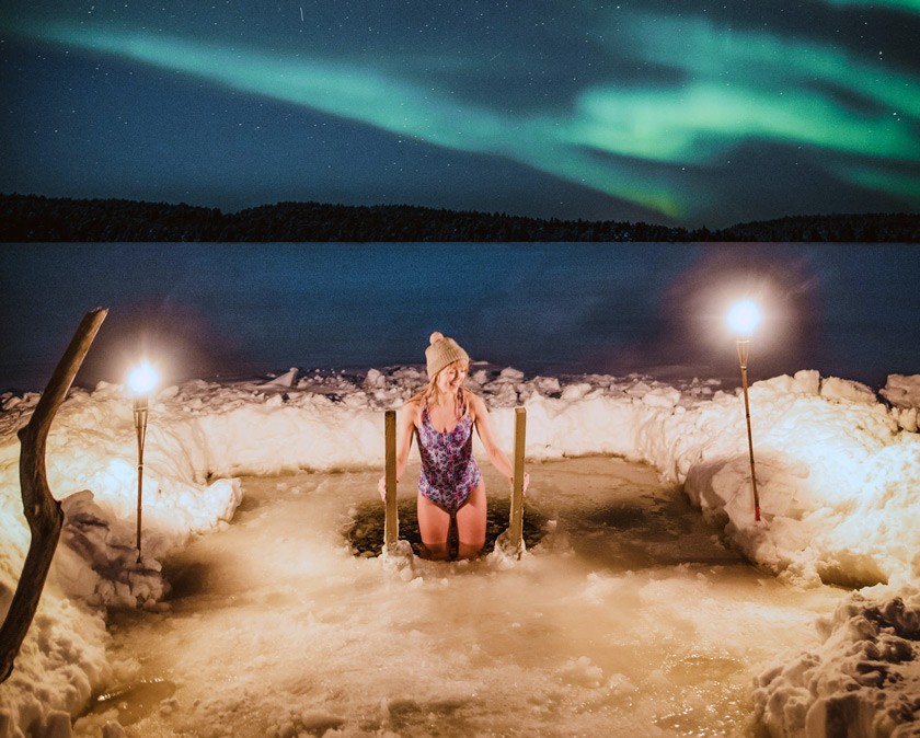 Ice swimming under the northern lights in Rovaniemi Credit: Toni Eskelinen ©Visit Rovaniemi