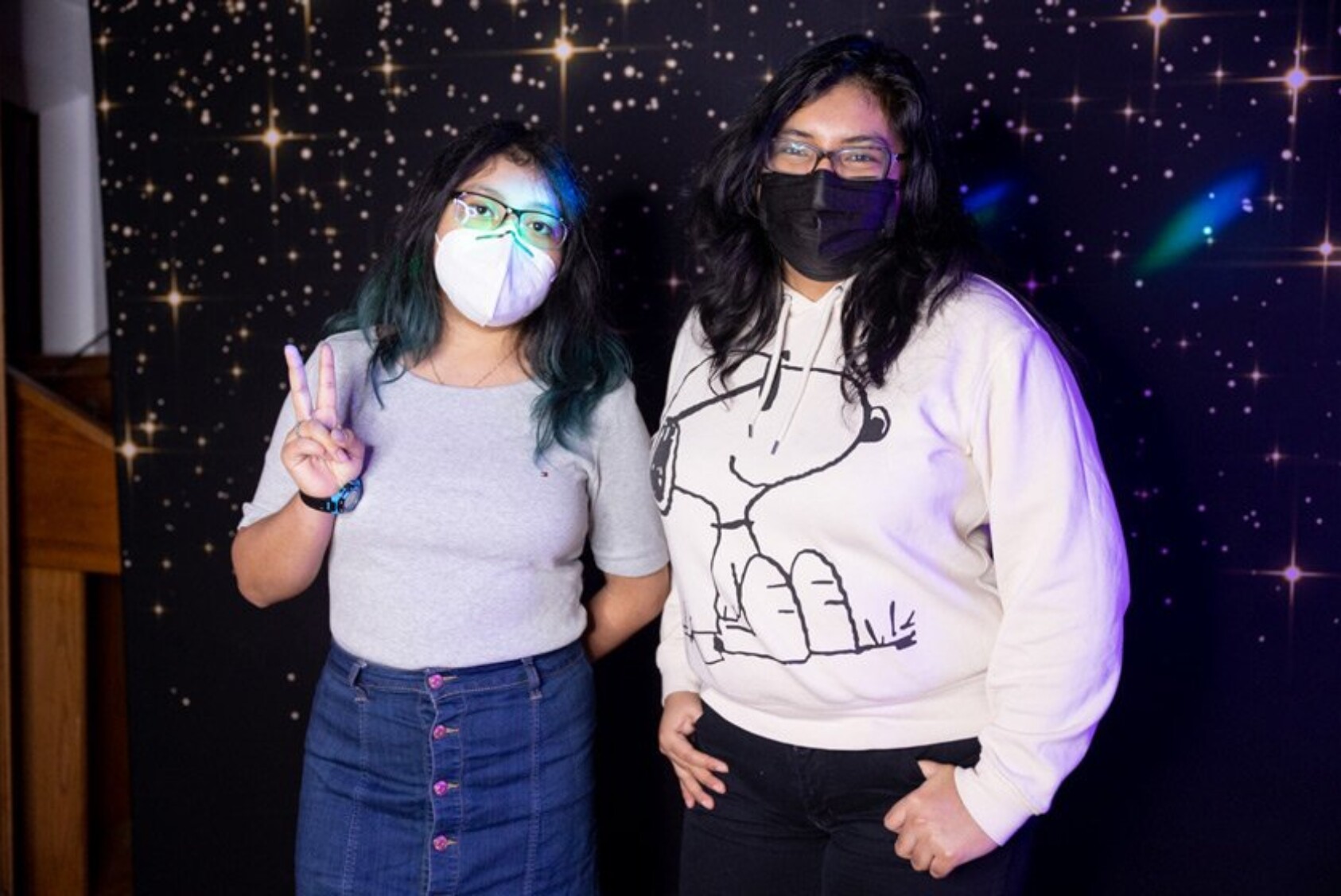 Yajaira Rodriguez ’24 in a skirt she borrowed from her sister and top from her mom, and Raquel Castromonte ’22 wearing her favorite Snoopy sweatshirt from high school