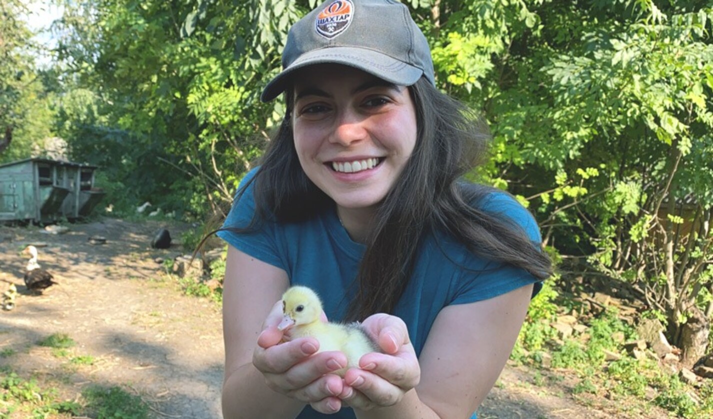 Maryna Mullerman DVM ’25 holds a duckling while visiting her grandparents in the countryside outside of Kharkiv, Ukraine, in August 2021