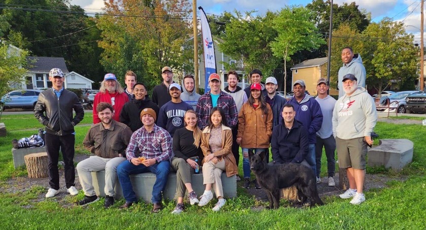 Matthew at the welcome back veterans barbecue social in September 2022; Philip Kay ’23 is sitting behind his service dog.