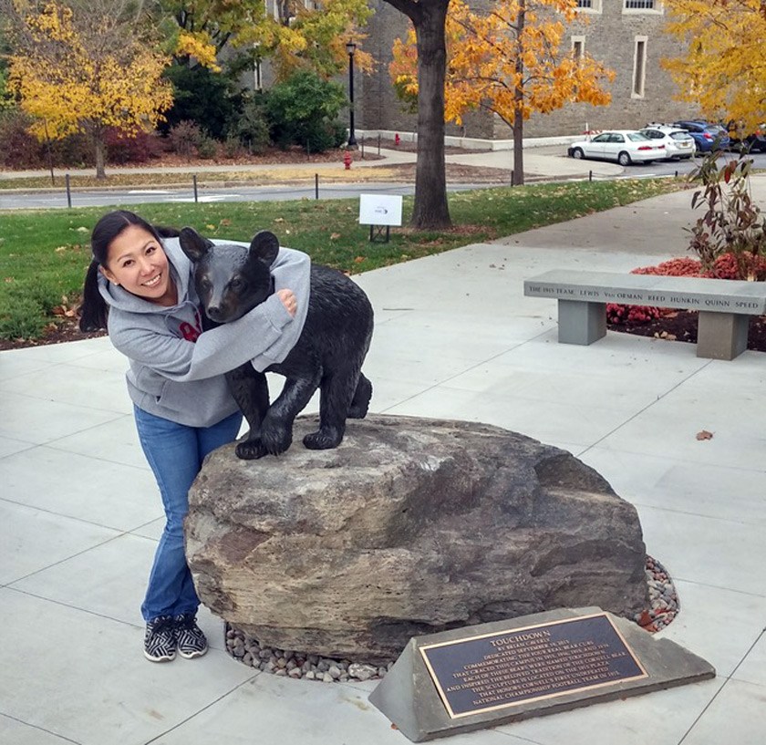 Rebecca Lee ’02 hugs Touchdown on a 2015 visit to campus for the Cornell China Conference.