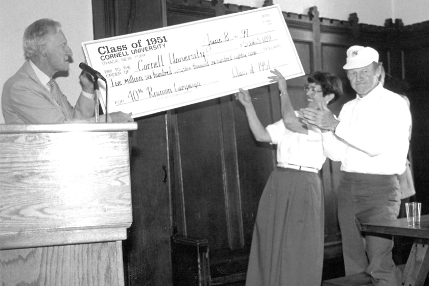 Mibs Follett holds a check at a presentation in 1991
