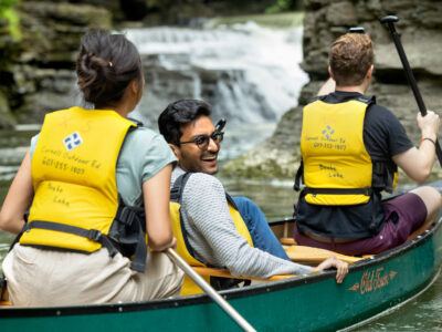 A trio in a canoe in the waters of Upstate New York