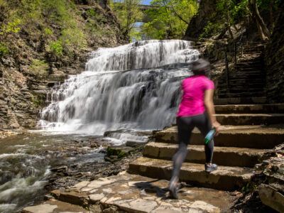 A hiker walks up Cascadilla Gorge