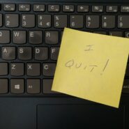 A keyboard with a yellow sticky note that reads "I Quit!"