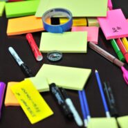 An assortment of brightly colored office supplies spread across a desk