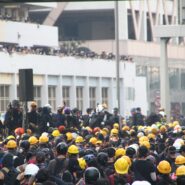 A crowd of workers wearing yellow hard hats