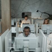 Individuals in small cubicles at a call center