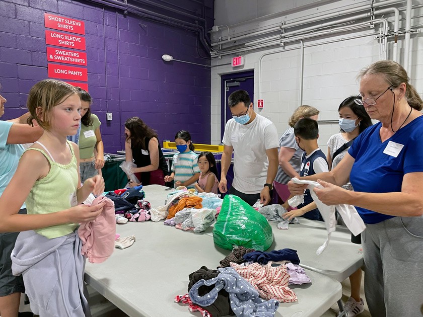 Members of the Cornell Club of Boston volunteered with Cradles to Crayons, a nonprofit that helps provide local children with clothing, books, and other goods they need to thrive.