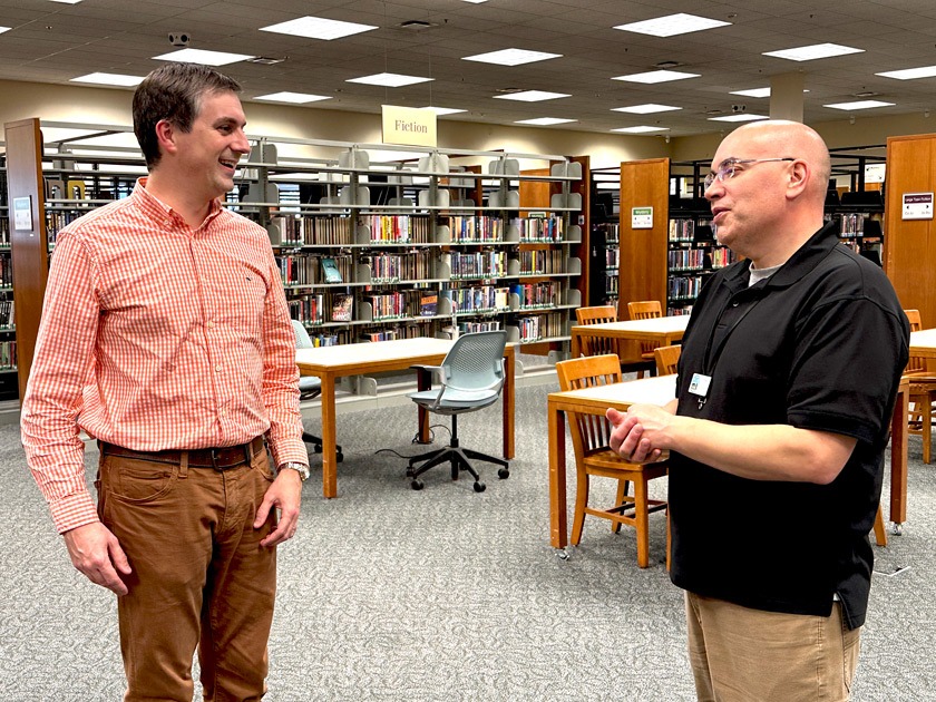 Thomas Godwin meets with Tom Fredette, digital librarian, at the site of the new VITA clinic at the Tompkins County Public Library.