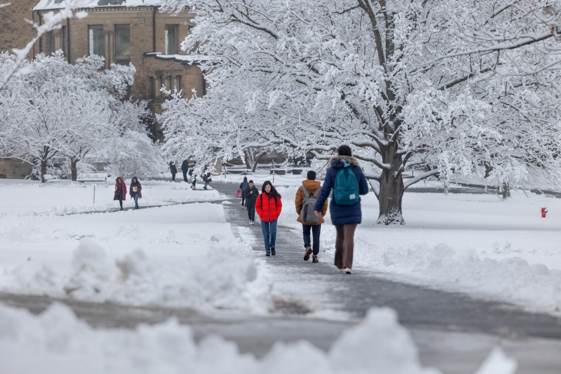 Students walk in the snow