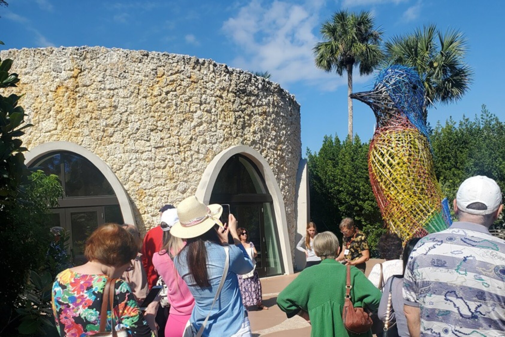 Event attendees view “Sietecolores” (Seven Colors), a sculpture of a painted bunting celebrating Miami’s first Hispanic Mayor, Maurice A. Ferré.