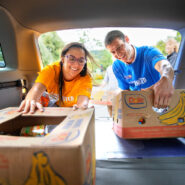 Community volunteers pack donated food into boxes and then load the boxes into vehicles for distribution to local food banks at the Stephen T. Garner Day of Caring at Stewart Park Sep. 12.
