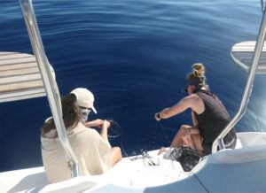 Whale team members deploy recording equipment to listen to humpback whales sing.