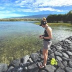 Samantha Juber listens to fish at Kaloko-Honokōhau National Historical Park.