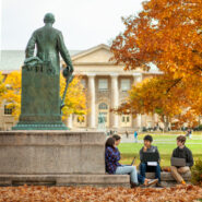 Students study near the statue of Ezra Cornell on the Arts Quad in fall. Students gathered next to the Ezra Cornell statue.