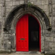 A red door of an old building in Ireland