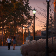 students on campus at sunset