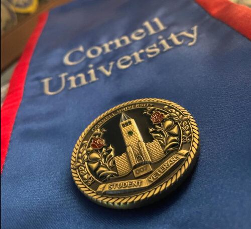 Cornell Student Veterans Coin, designed by Indigo Routh ’24, is awarded to all graduating student veterans and key university staff members who have played a pivotal role in supporting them.