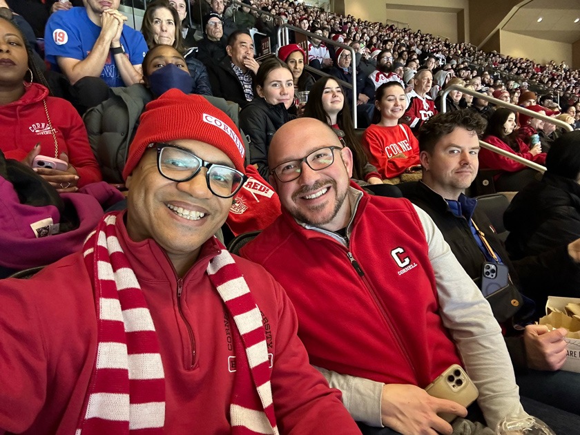 Morgan Jones MBA ’15 (L) and Matt Carcella (R), senior director of diversity and U.S. regional alumni engagement, enjoy Cornell’s victory over Boston University at Red Hot Hockey in Madison Square Garden in 2023.