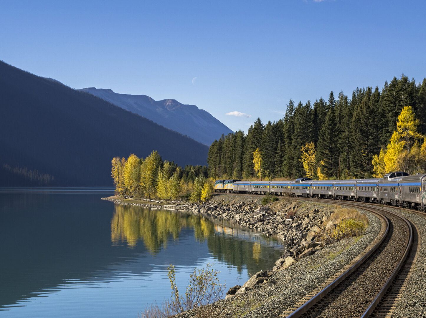 Passenger train along Moose Lake in Canada