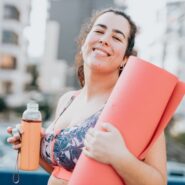 person carrying yoga mat