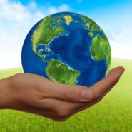 a hand holding a planet Earth