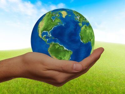 a hand holding a planet Earth
