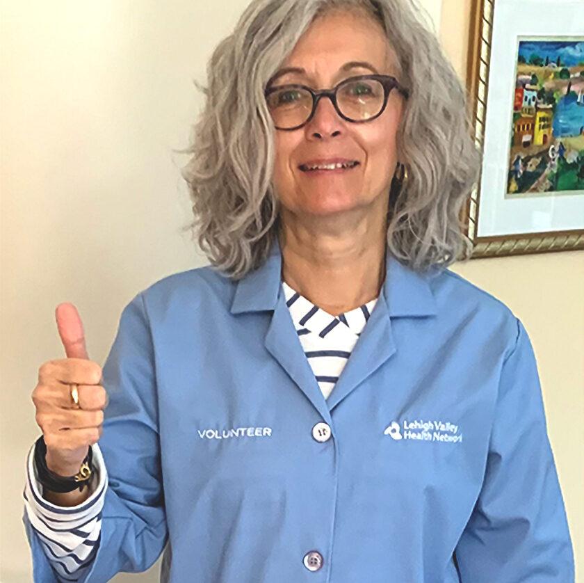 Kelly in her scrubs outside the neonatal intensive care unit at Lehigh Valley Heath Network, where she volunteers to cuddle infants.