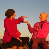 Two people atop Saharan sand dune
