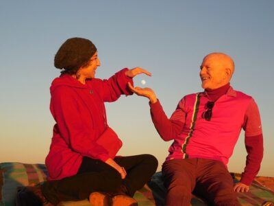 Two people atop Saharan sand dune