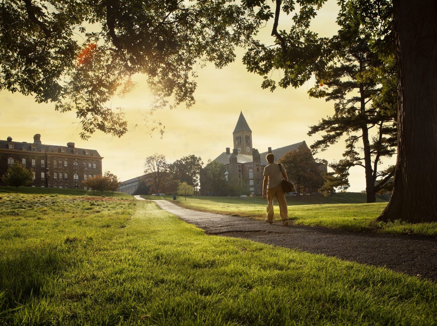 A student walks up Libe Slope in fall.