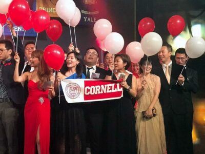 Isaac Wong '00 (2nd from right in gold tie) and his wife Cecilia (in gold dress) join other Cornellians at the 2017 Ivy Ball at the Hong Kong Convention Center.