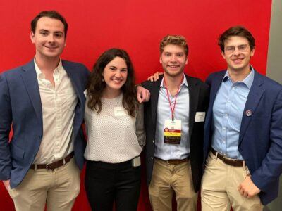 Seniors Luke Denver-Moore, Abigail Boatmun, Daniel Morgan, and Gabe Schiffer attending a student networking event with trustees and Cornell leaders during TCAM
