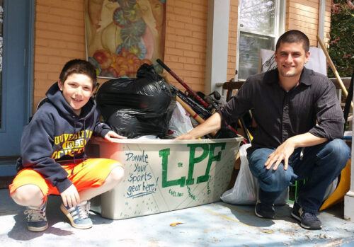 The first project Melissa’s son Shane (left) took on back in 2014 was helping LPF’s founder Max Levitt (right) decorate bins for collecting used sports gear.
