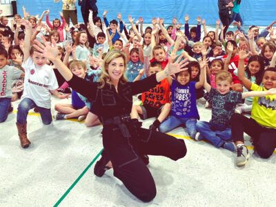 Author Heather Alexander ’89 posing happily with children