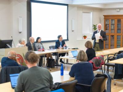 A panel of faculty sit at a table
