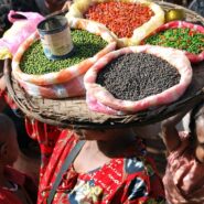 person carrying tray of lentils