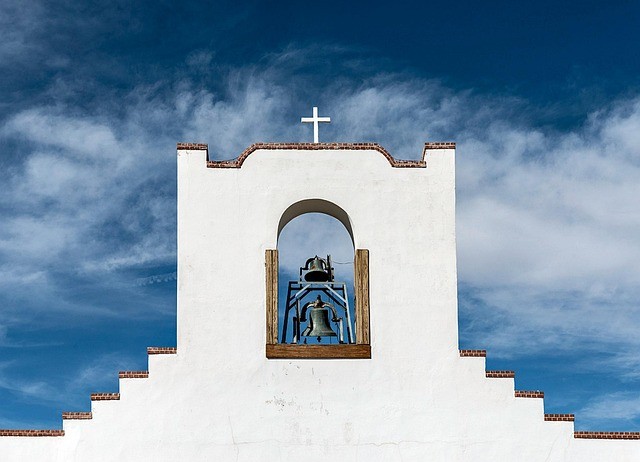 adobe church set against blue sky