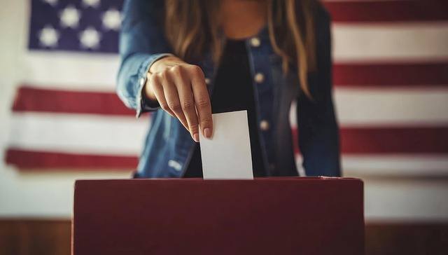 Woman casting paper ballot
