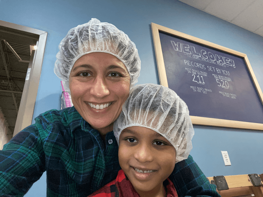 The good Cornellians can do: Mythily Kamath Georges MBA ’08 – Mythily volunteers with her family at Feed My Starving Children.