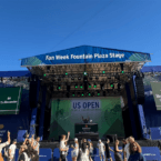 US Open Fan Week stage outside with people dancing in front of it