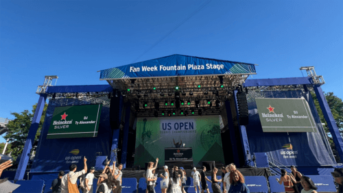 US Open Fan Week stage outside with people dancing in front of it